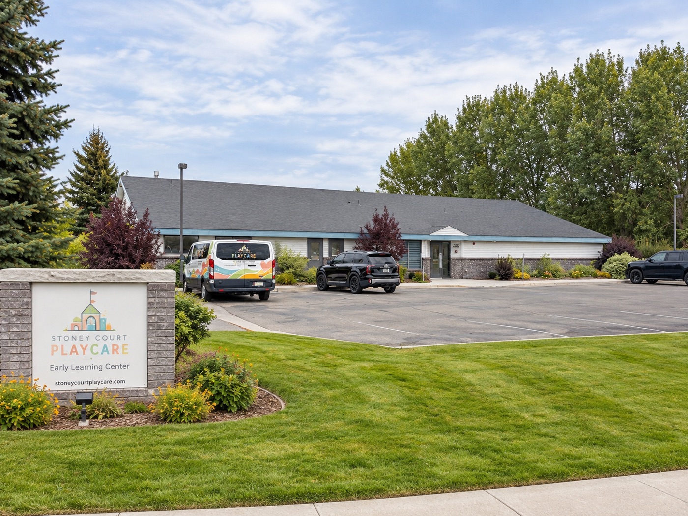 The front of Stoney Court Playcare with our sign and van